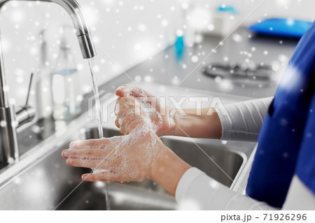 doctor or nurse washing hands with liquid soap doctor or nurse washing hands with liquid soap 71926296