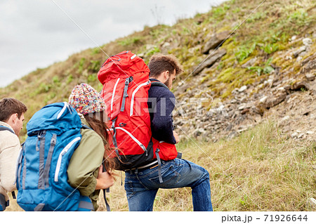 group of friends with backpacks hiking 71926644