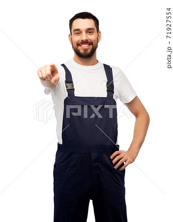smiling male worker or builder pointing to camera smiling male worker or builder pointing to camera 71927554