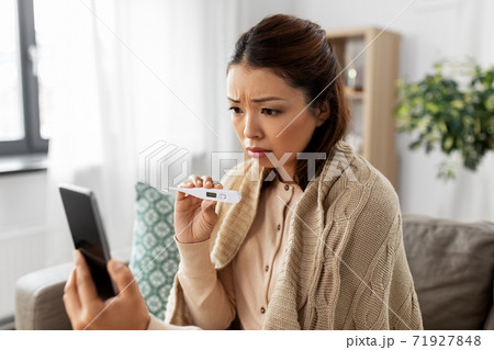 sick woman having video call on smartphone sick woman having video call on smartphone 71927848