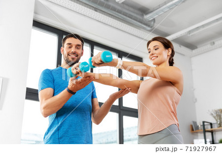 happy couple exercising at home 71927967