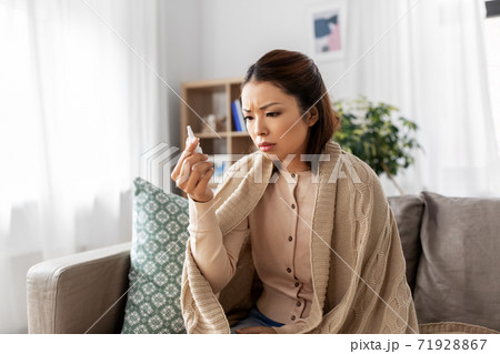 sick asian woman with nasal spray medicine at home sick asian woman with nasal spray medicine at home 71928867