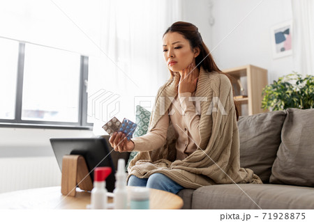 sick woman with medicine has video consultation sick woman with medicine has video consultation 71928875