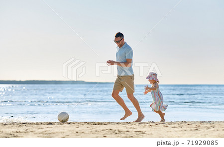 happy father and daughter playing ball on beach happy father and daughter playing ball on beach 71929085