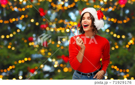 happy young woman in santa hat on christmas happy young woman in santa hat on christmas 71929176