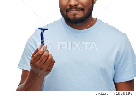 close up of african american man with razor blade 71929196