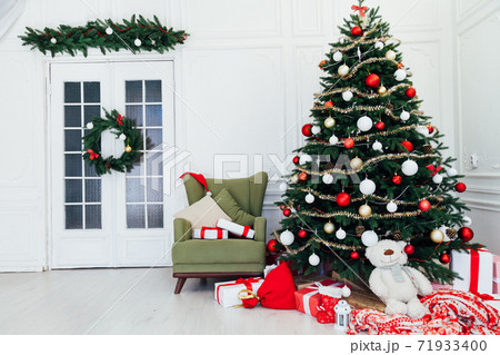 December Christmas tree pine with gifts new year interior decor 71933400