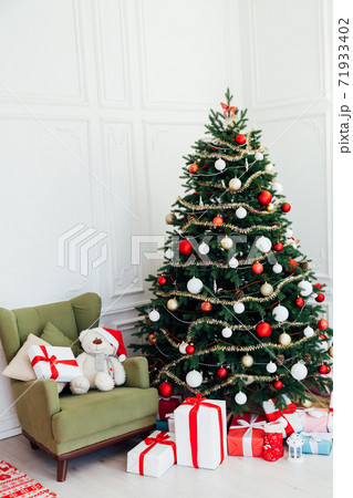December Christmas tree pine with gifts new year interior decor 71933402