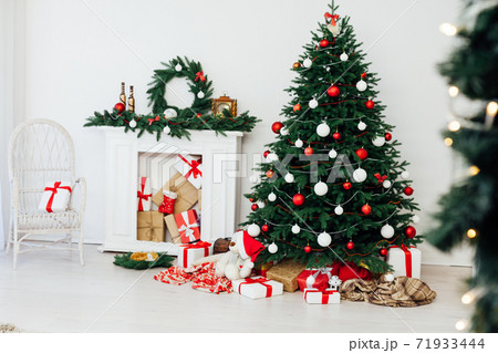 White room christmas tree pine fireplace with new year decoration gifts White room christmas tree pine fireplace with new year decoration gifts 71933444