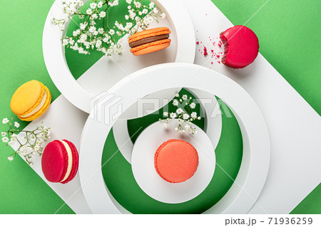 Cake macaron or macaroon on green background Cake macaron or macaroon on green background 71936259