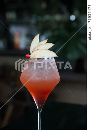 Pink Cocktail glass with ice at a bar counter Pink Cocktail glass with ice at a bar counter 71936478
