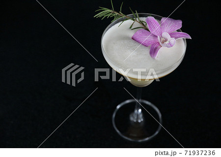 Pink Cocktail glass with ice at a bar counter Pink Cocktail glass with ice at a bar counter 71937236