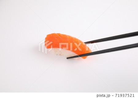 Salmon sushi with chopsticks Japanese food isolated in white background 71937521