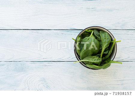 Closeup of spinach leaves on white wooden table 71938157