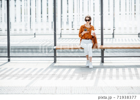 Woman at the public transport stop Woman at the public transport stop 71938377