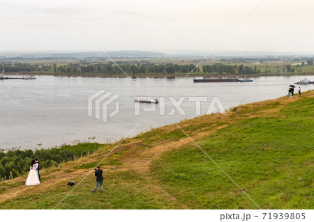 Elabuga, Tatarstan, Russia 30 July 2020: photo session photographer takes photos of bride and groom Elabuga, Tatarstan, Russia 30 July 2020: photo session photographer takes photos of bride and groom 71939805