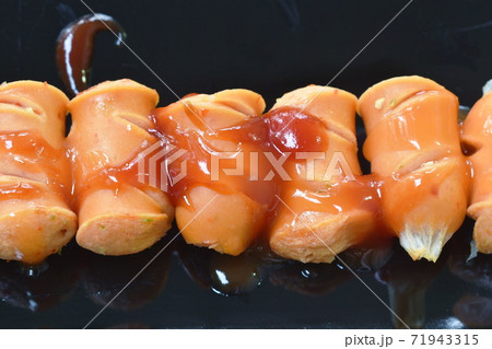 pork sausage dressing ketchup and chili sauce on plate 71943315