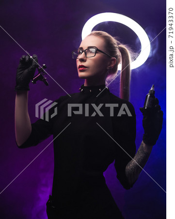 a woman with a halo in black clothes with a tattoo machine a woman with a halo in black clothes with a tattoo machine 71943370