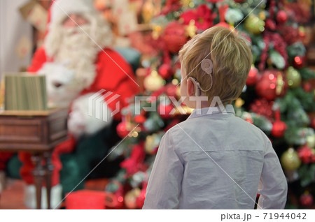 A Boy with Cochlear Implants and Santa Claus A Boy with Cochlear Implants and Santa Claus 71944042