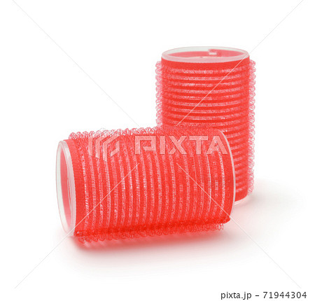 Red hair curlers isolated on white. 71944304