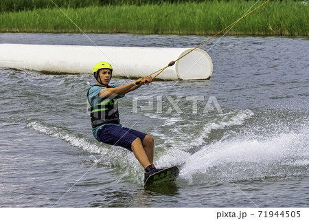Teenager wakeboarding on a lake - Brwinow, Masovia, Poland 71944505