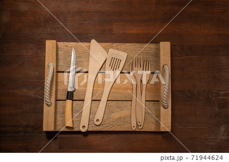 Kitchen wooden utensils on wooden table horizontal banner layout. Top view on wooden table background Kitchen wooden utensils on wooden table horizontal banner layout. Top view on wooden table background 71944624