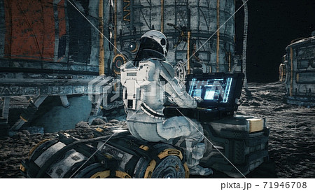 An astronaut works on his laptop at a space base on one of the new planets. 3D Rendering. An astronaut works on his laptop at a space base on one of the new planets. 3D Rendering. 71946708