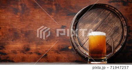 Mug of light lager beer and old wooden barrel Mug of light lager beer and old wooden barrel 71947257