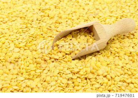 Yellow Lentils and wooden spoon Yellow Lentils and wooden spoon 71947601