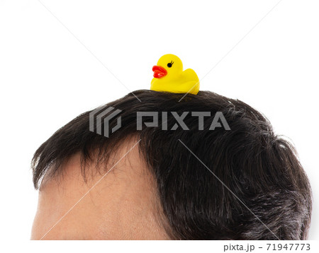 Yellow inflatable duck on head symbol of the Thai protests Yellow inflatable duck on head symbol of the Thai protests 71947773