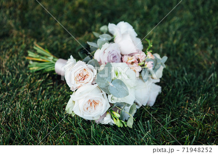 Beautiful wedding bouquet on a background of grass. Beautiful wedding bouquet on a background of grass. 71948252