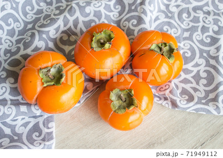 Fresh ripe persimmon, persimmon. Vitamins in the winter Fresh ripe persimmon, persimmon. Vitamins in the winter 71949112