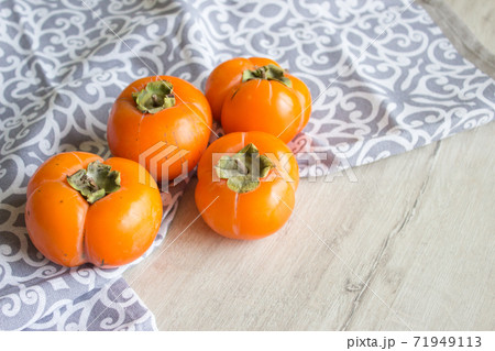 Fresh ripe persimmon, persimmon. Vitamins in the winter Fresh ripe persimmon, persimmon. Vitamins in the winter 71949113