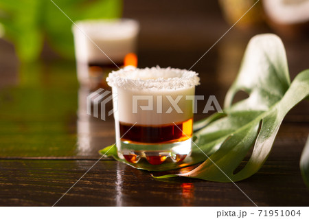 Tropical alcoholic shots decorated with coconut flakes Tropical alcoholic shots decorated with coconut flakes 71951004