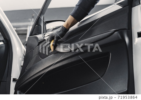 Man polish salon of car in a garage 71953864