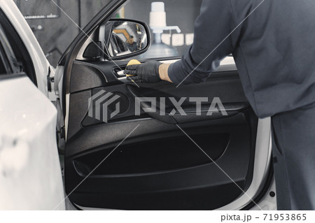 Man polish salon of car in a garage Man polish salon of car in a garage 71953865