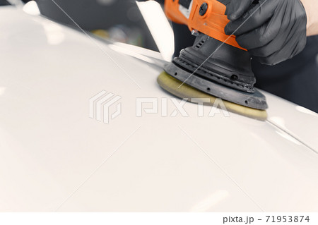 Man polish a car in a garage Man polish a car in a garage 71953874