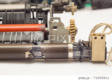 view of a worn, damaged, torn metal thermal film from a laser printer 71956911