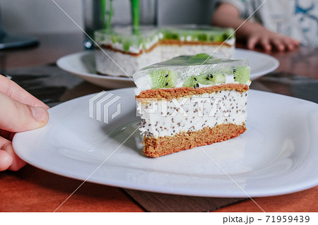 Raw vegan kiwi green cake decorated with slices. Coconut chia filling jelly vegetarian cashew cream cheesecake gluten free. Lactose sugar free holiday organic desert. Healthy eco cake Raw vegan kiwi green cake decorated with slices. Coconut chia filling jelly vegetarian cashew cream cheesecake gluten free. Lactose sugar free holiday organic desert. Healthy eco cake 71959439