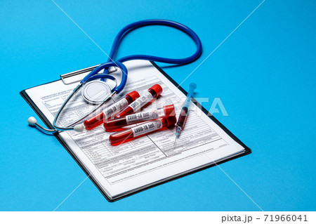 Clipboard with paper blank form with medical tools on blue background with cope space Clipboard with paper blank form with medical tools on blue background with cope space 71966041