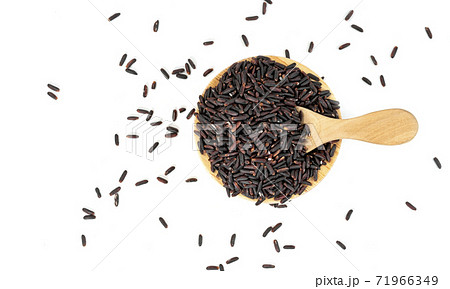dark violet rice berry with wooden bowl and spoon isolated on white background dark violet rice berry with wooden bowl and spoon isolated on white background 71966349