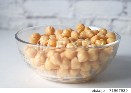 chick peas in a bowl on white background  71967929