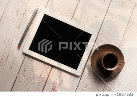 Flat composition of digital tablet and tea on wooden background  71967932