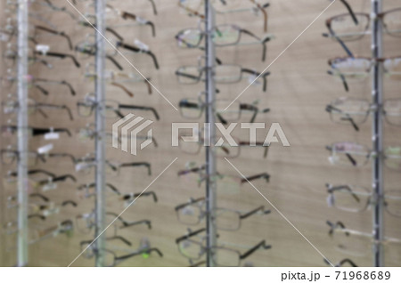 Blurred optics store with a large selection of fashionable eyeglass frames Blurred optics store with a large selection of fashionable eyeglass frames 71968689