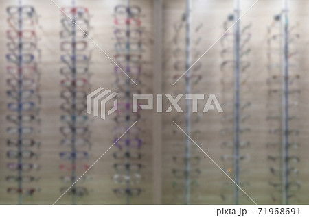 Blurred storefront with glasses in an optics store Blurred storefront with glasses in an optics store 71968691