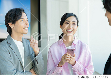 カフェで立ち話をする若い男女 カフェで立ち話をする若い男女 71968835