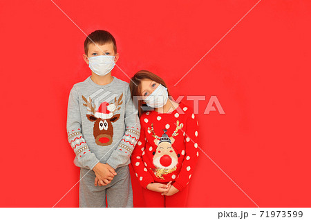 A boy and a girl wearing respiratory masks keep their distance A boy and a girl wearing respiratory masks keep their distance 71973599
