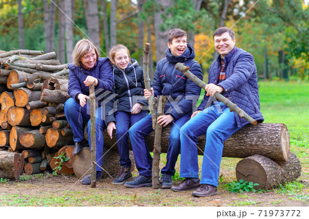family relaxing outdoor in autumn city park, happy people together, parents and children, they playing, talking and smiling, beautiful nature family relaxing outdoor in autumn city park, happy people together, parents and children, they playing, talking and smiling, beautiful nature 71973772