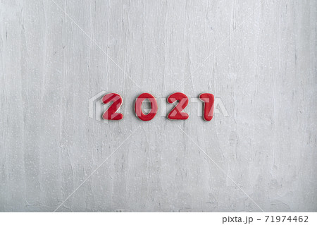 Inscription in red numbers 2021 from gingerbread on gray background. New Year 2021, copy space 71974462