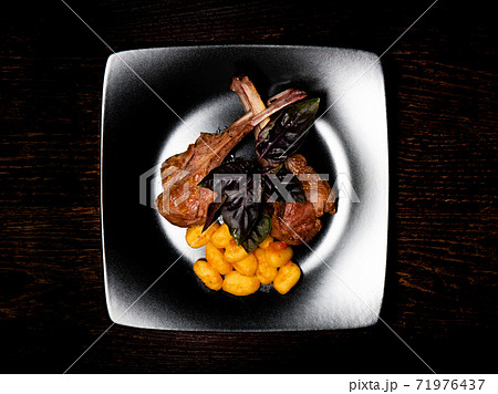 Grilled meat on a plate. Restaurant food. Lamb rack dish with pasta. Grilled meat on a plate. Restaurant food. Lamb rack dish with pasta. 71976437